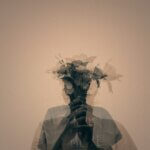 gray scale photo of man holding flower